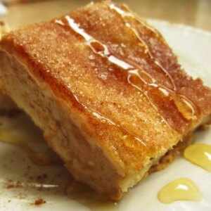 Close up view of a piece of sopapilla cheesecake dessert on a plate