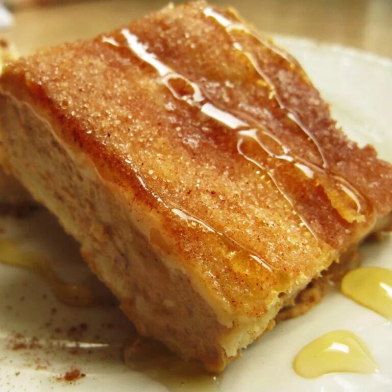 Close up view of a piece of sopapilla cheesecake dessert on a plate
