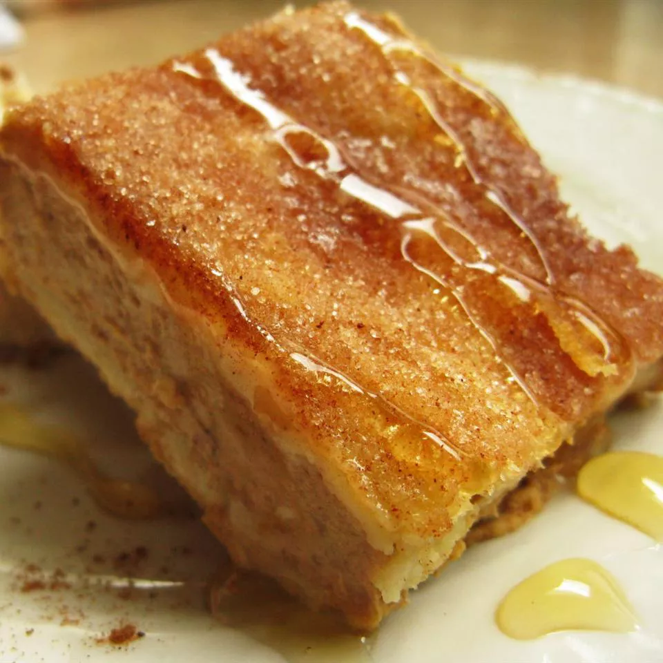 Close up view of a piece of sopapilla cheesecake dessert on a plate