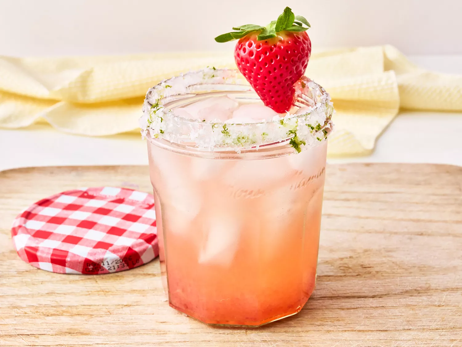Pink cocktail in mason jar with strawberry