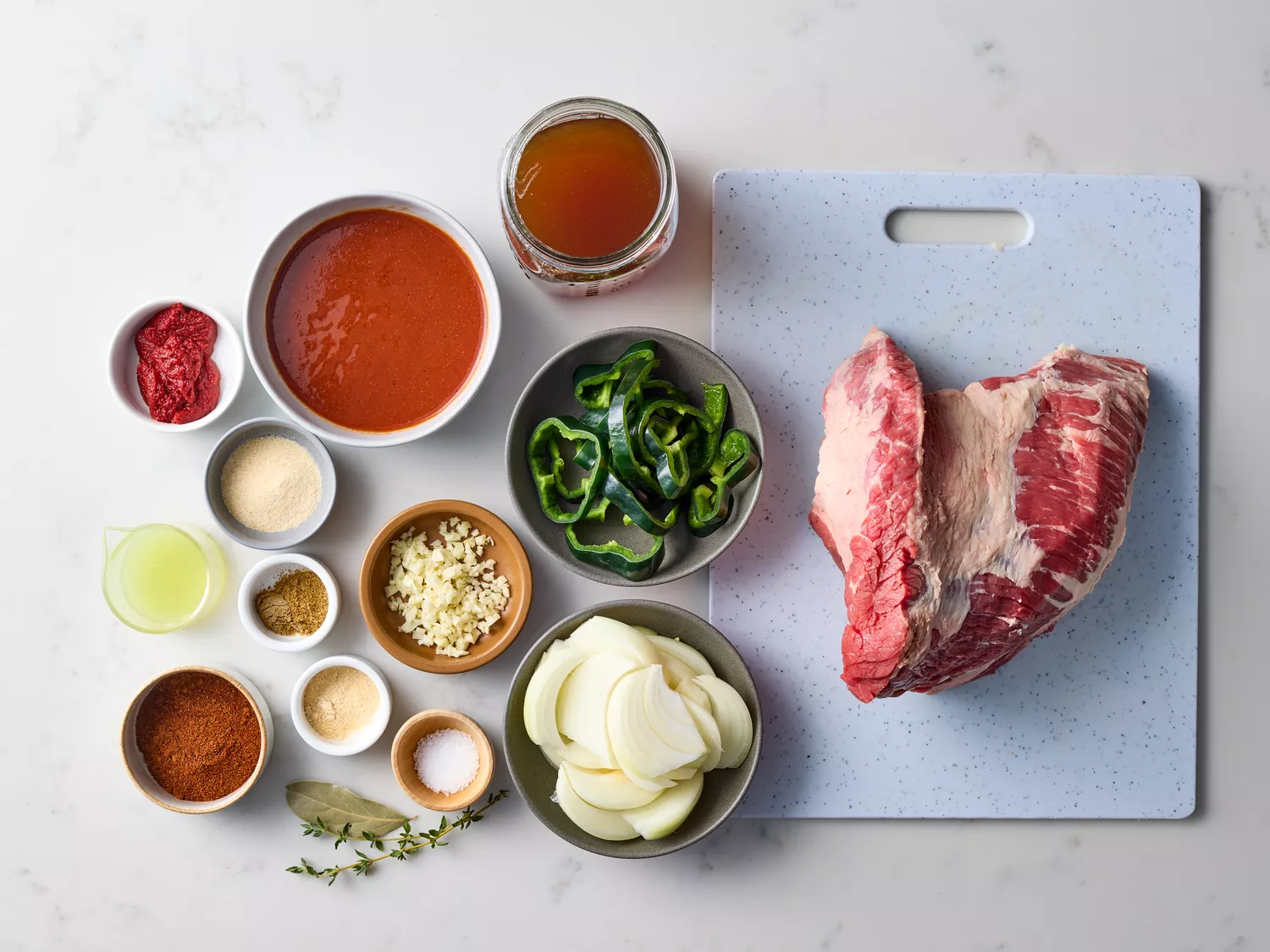 Slow Cooker Brisket Tacos recipe ingredients on a marble counter 