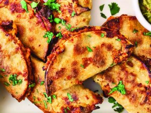 Overhead closeup of tacos baked on a sheet pan