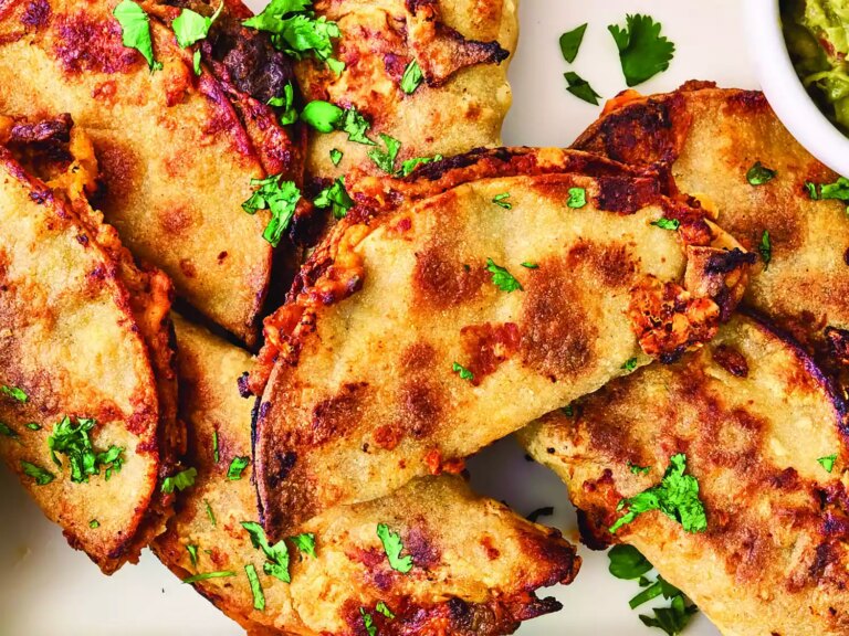 Overhead closeup of tacos baked on a sheet pan
