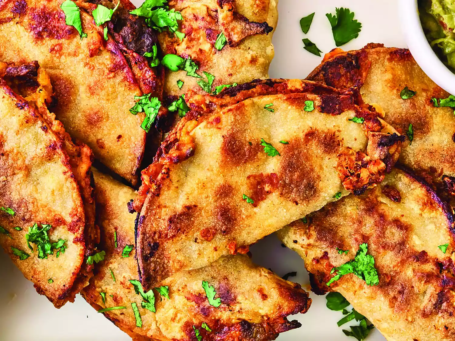 Overhead closeup of tacos baked on a sheet pan
