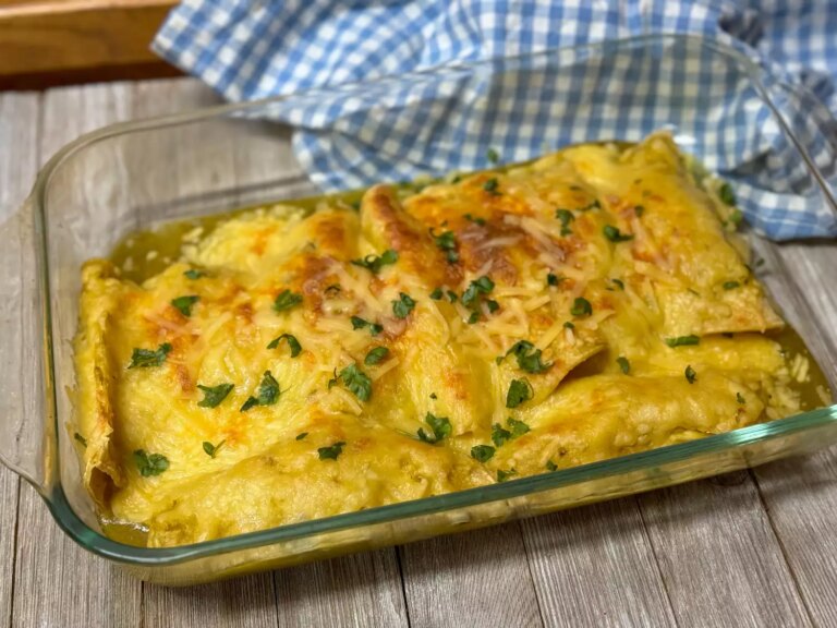 Glass casserole dish of ham, egg, and cheese enchiladas