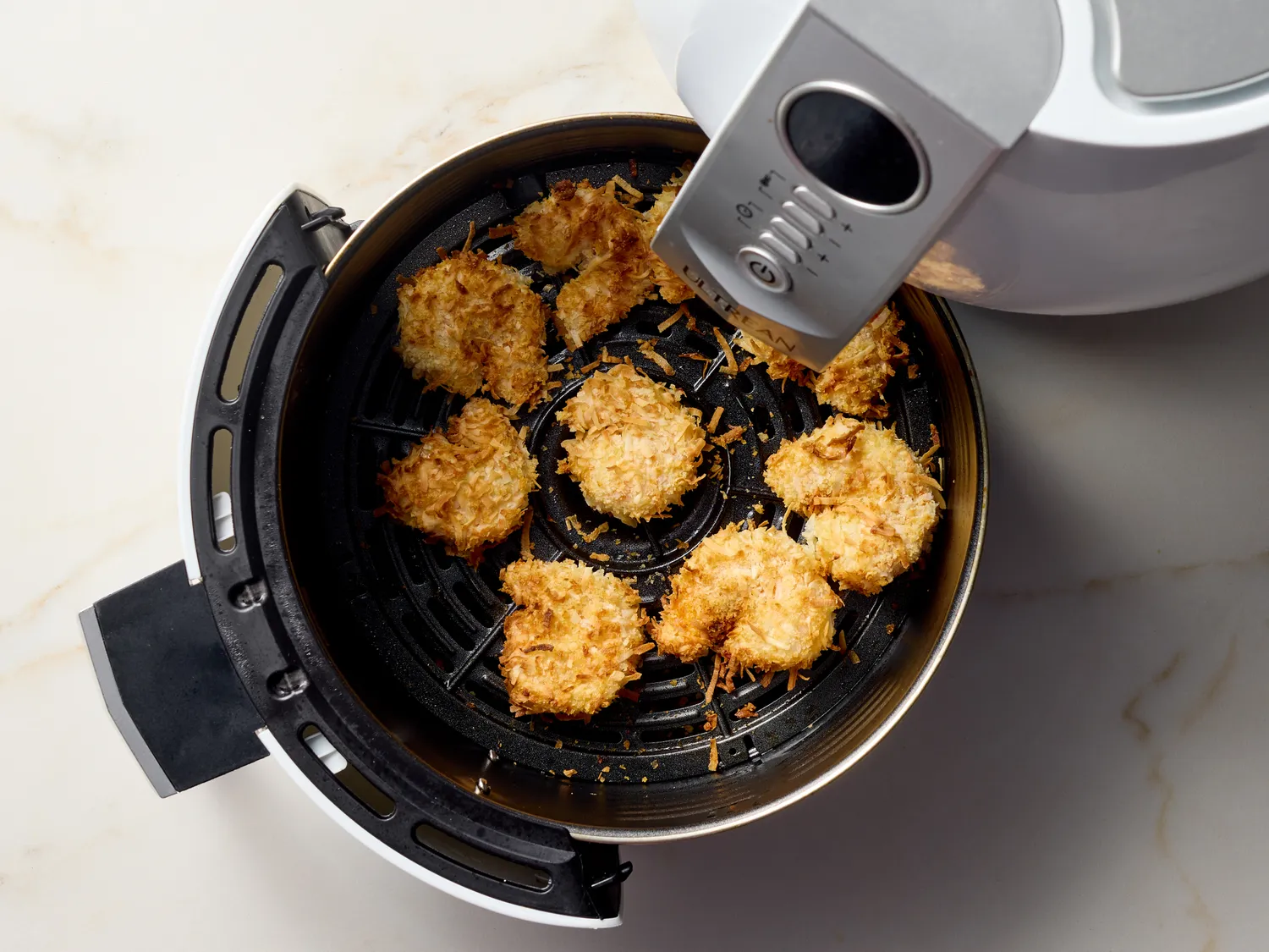 Coconut shrimp cooking in an air fryer