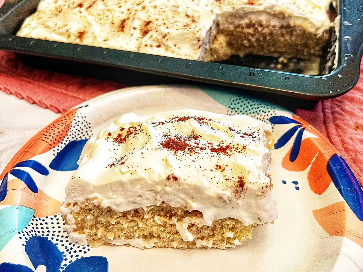 Vanilla cake slice soaked in horchata and topped with whipped cream and cinnamon