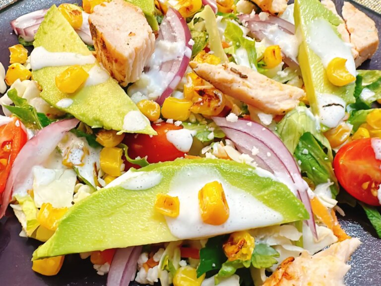 Chopped mexican salad with corn, chicken and cheese sauce