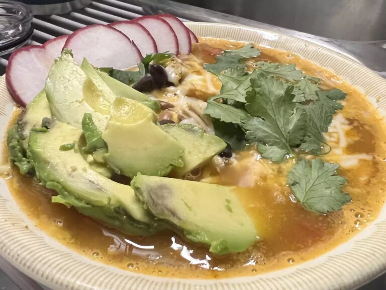 Tortilla and bean soup with avocado and radishes