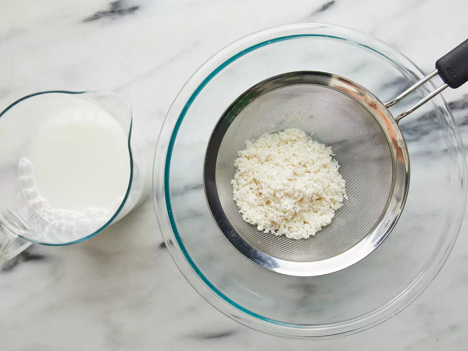 Rice water strained into pitcher, discarding rice. 