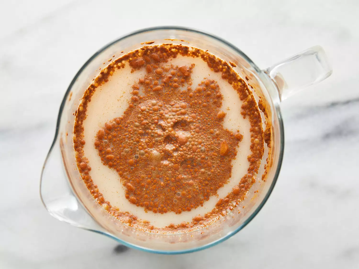 Sugar, milk, vanilla and cinnamon stirred into the pitcher of rice water.