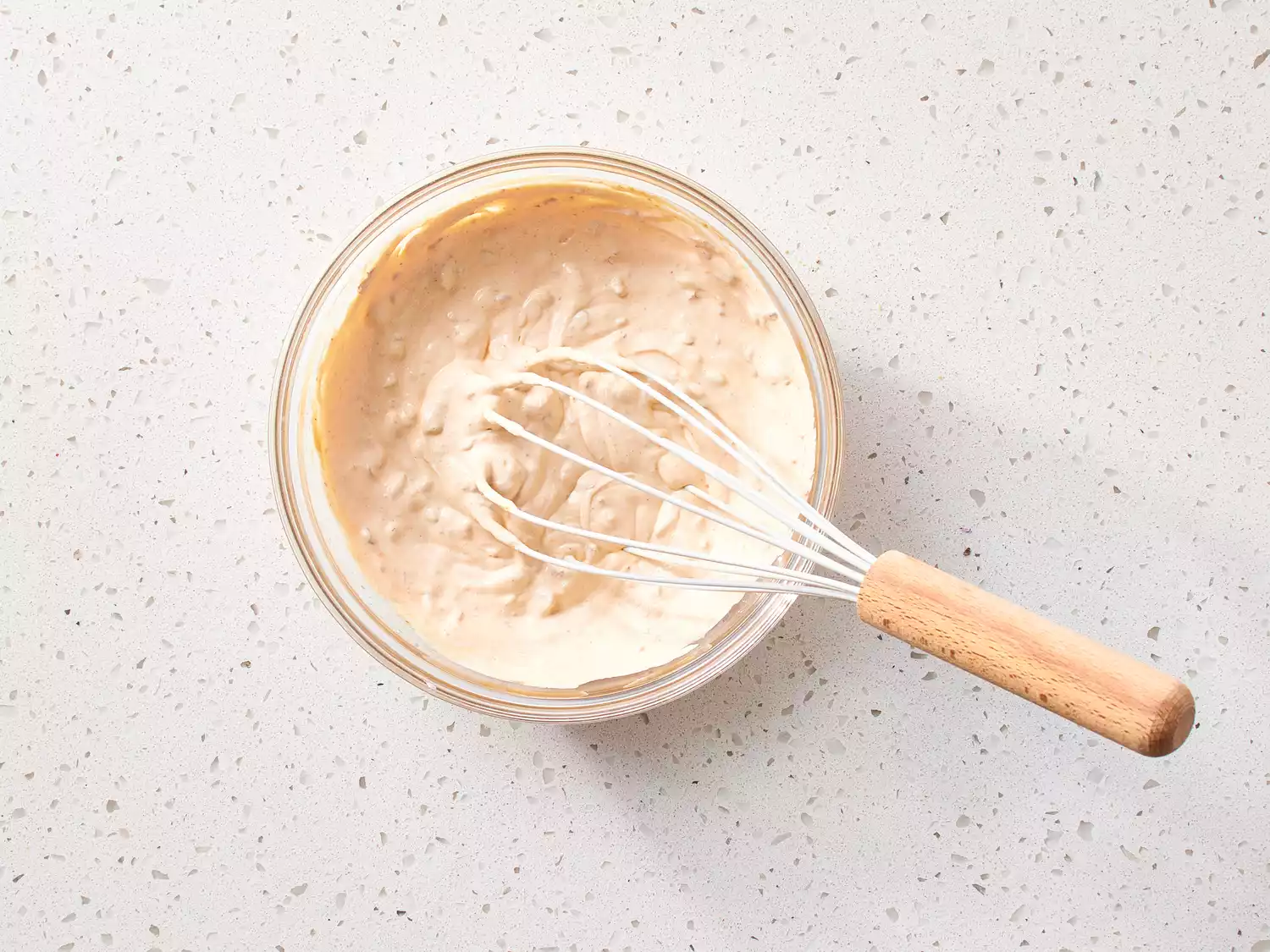 Chipotle-Lime Dressing in a glass bowl with a whisk