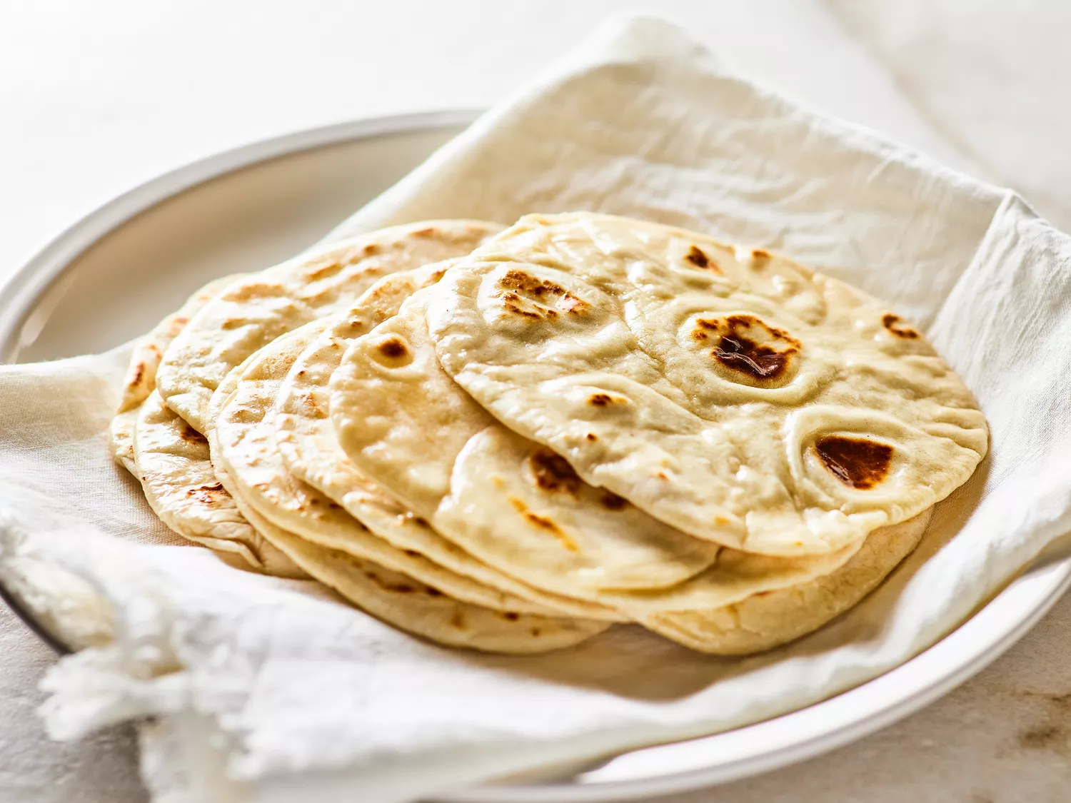 close up on a plate of homemade flour tortillas