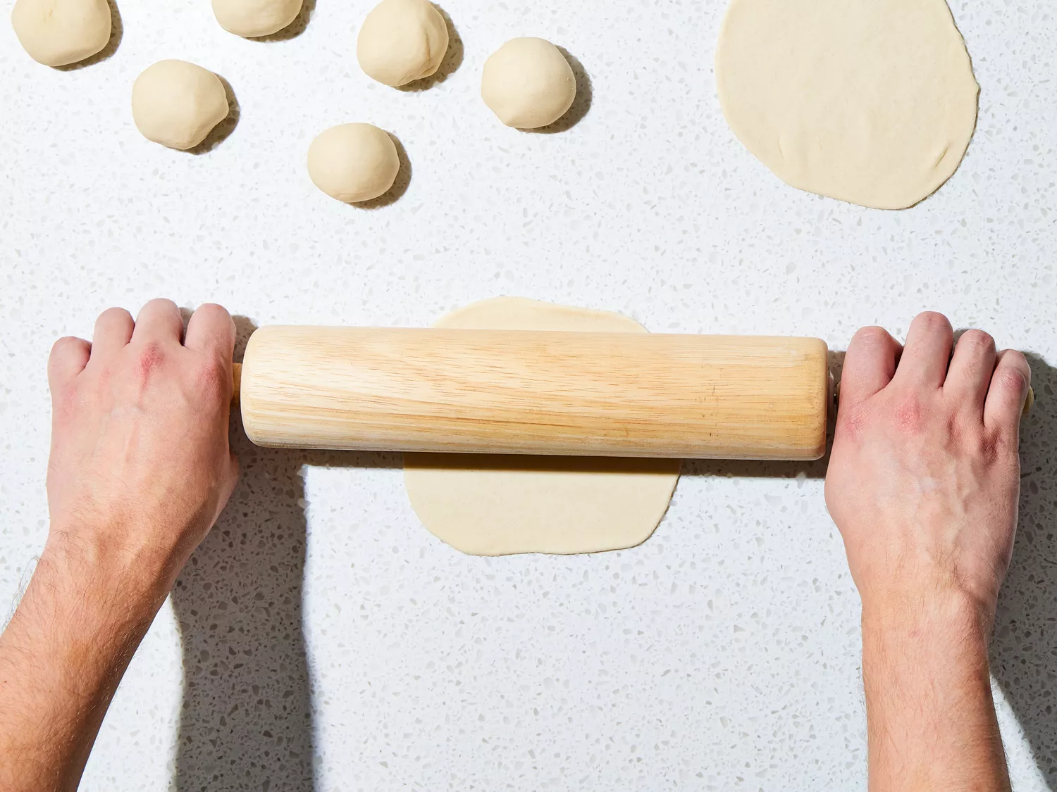 dough divided into pieces and rolled out