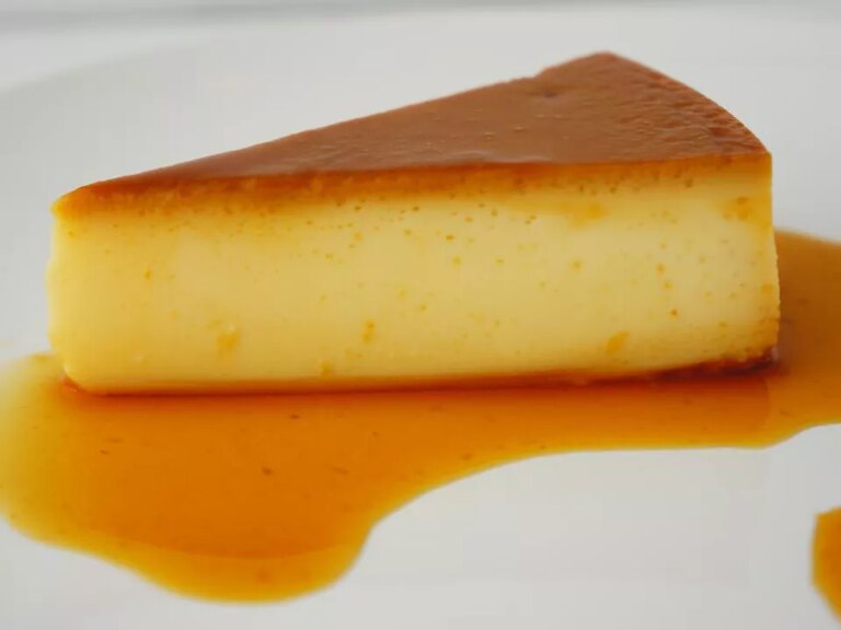 Close up view of a slice of quesillo (venezuelan flan) on a white plate