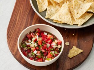 Looking down at a small bowl of salsa, with a side of tortilla chips.