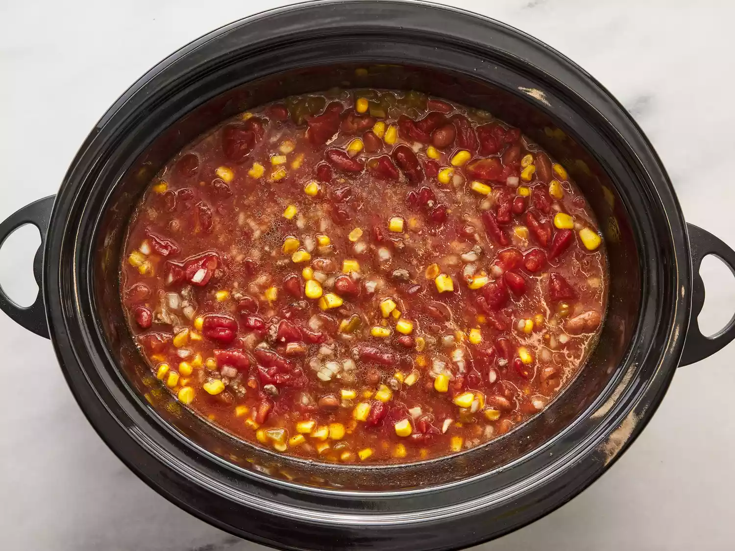 All ingredients mixed together in the slow cooker.