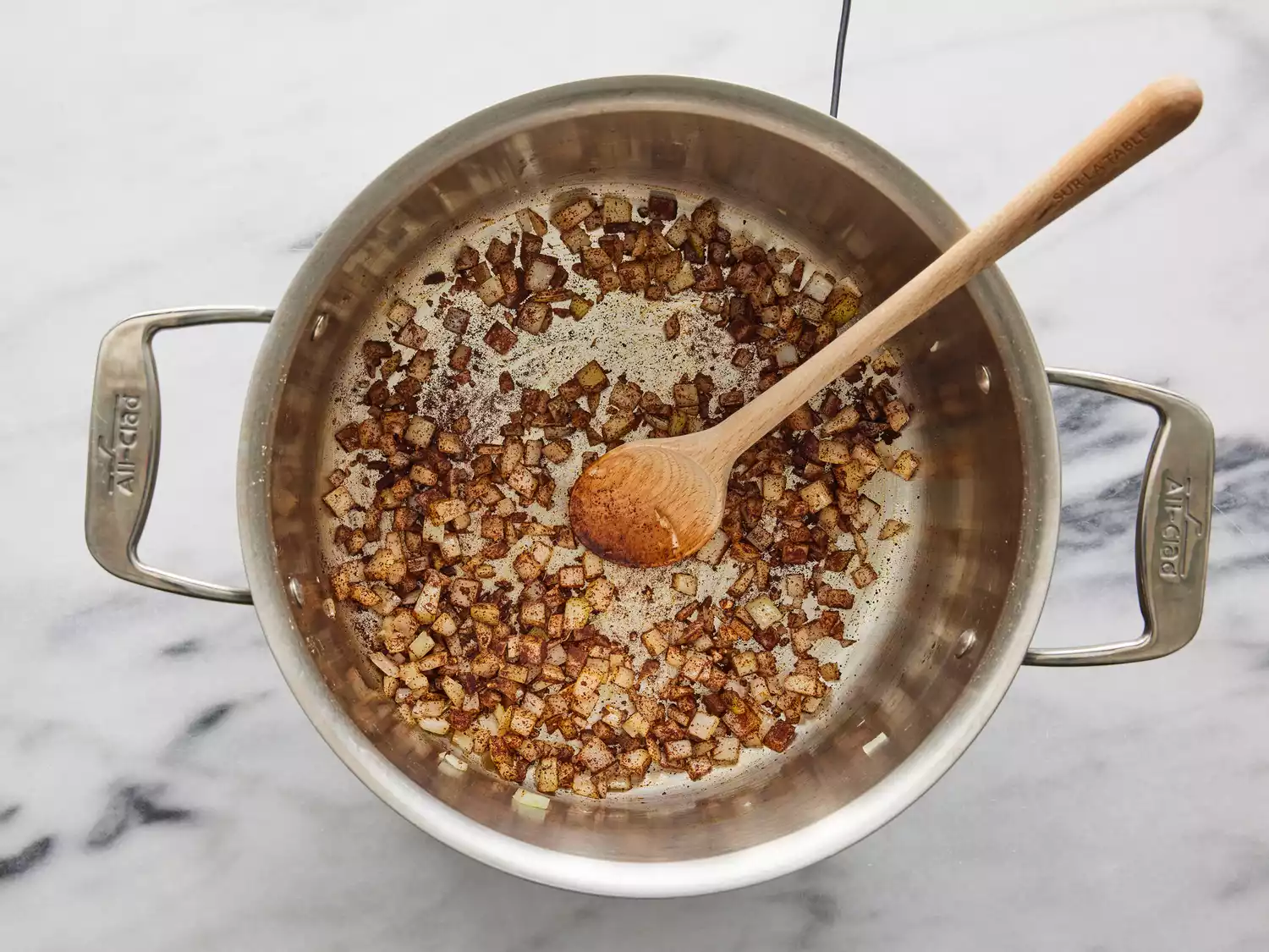 Onions and seasonings cooking in pan until fragrant. 