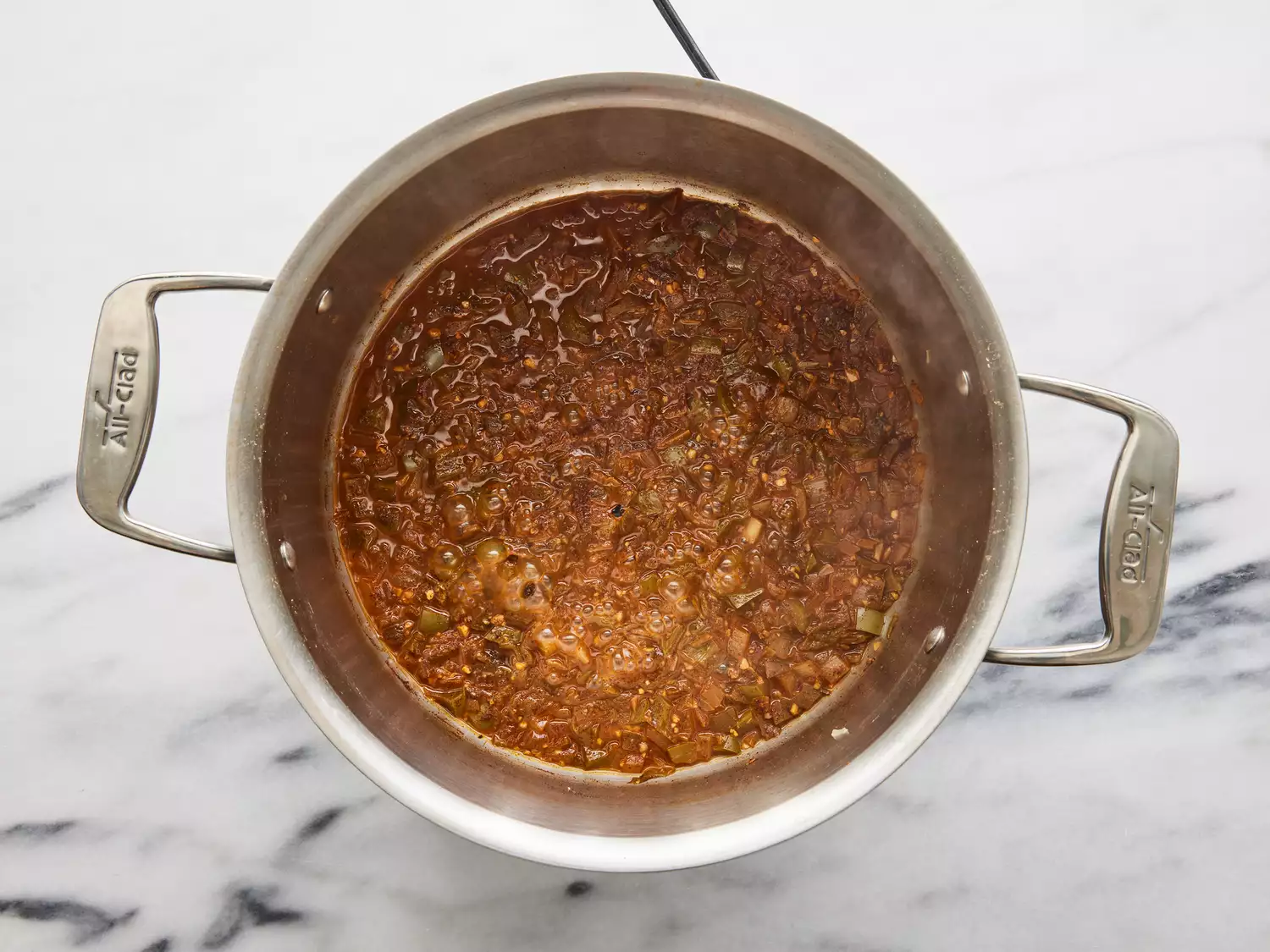 more ingredients added to pot, covering and left to simmer. 