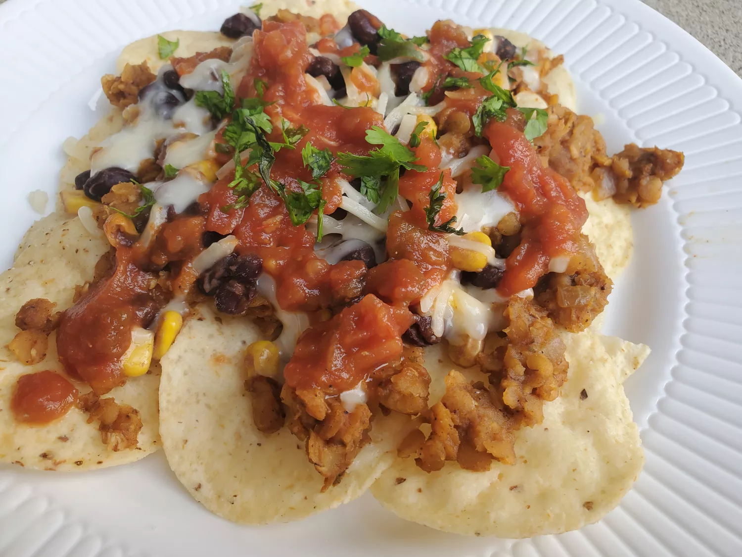 Nachos with lentils, cheese, and salsa