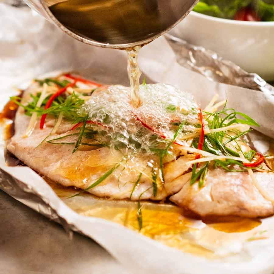 Sizzling Ginger Steamed Fish Recipe Pouring hot oil over Sizzling ginger fish