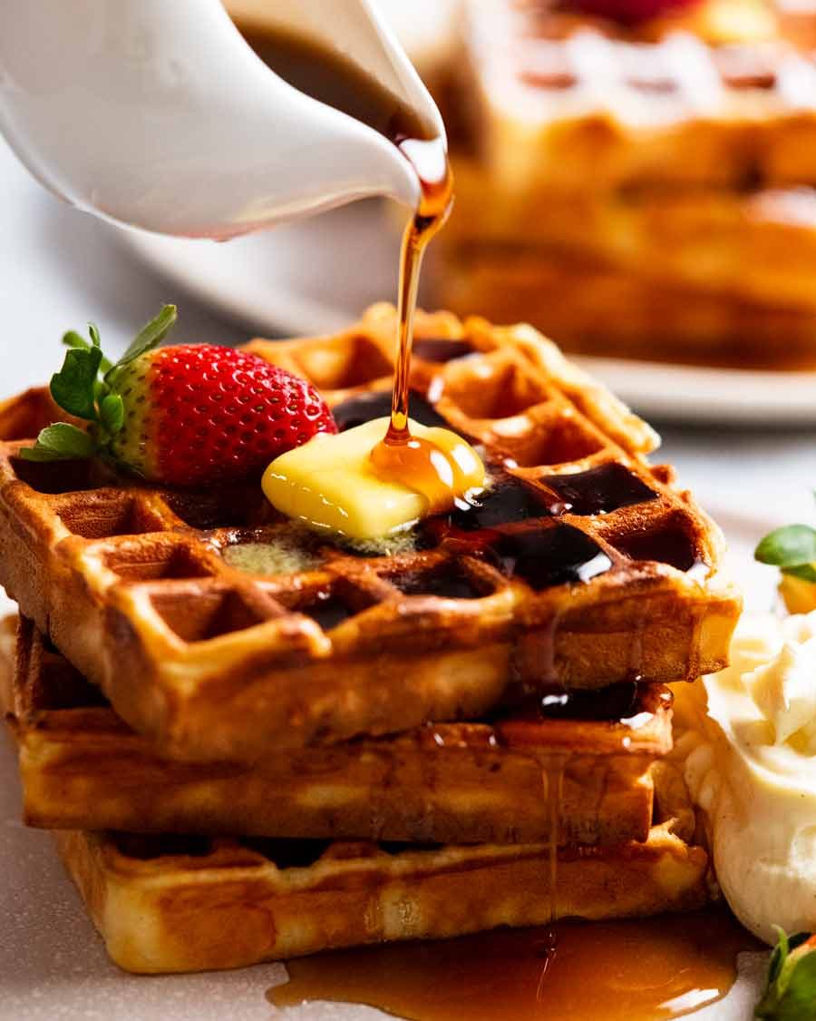 Waffles Recipe Pouring syrup over stack of Waffles