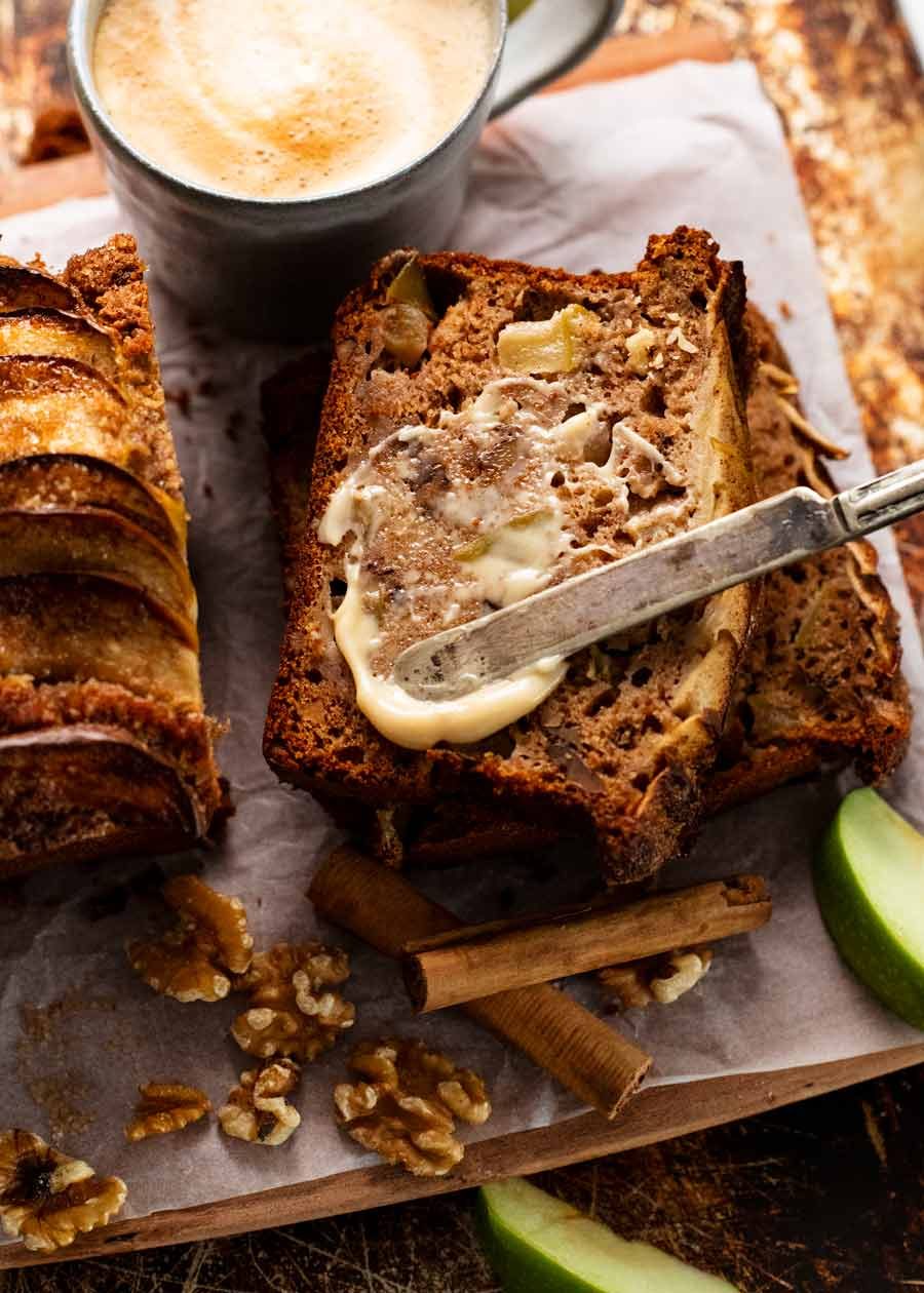 Cinnamon Apple Bread Recipe Spreading butter onto a lightly toasted slice of Cinnamon Apple Bread
