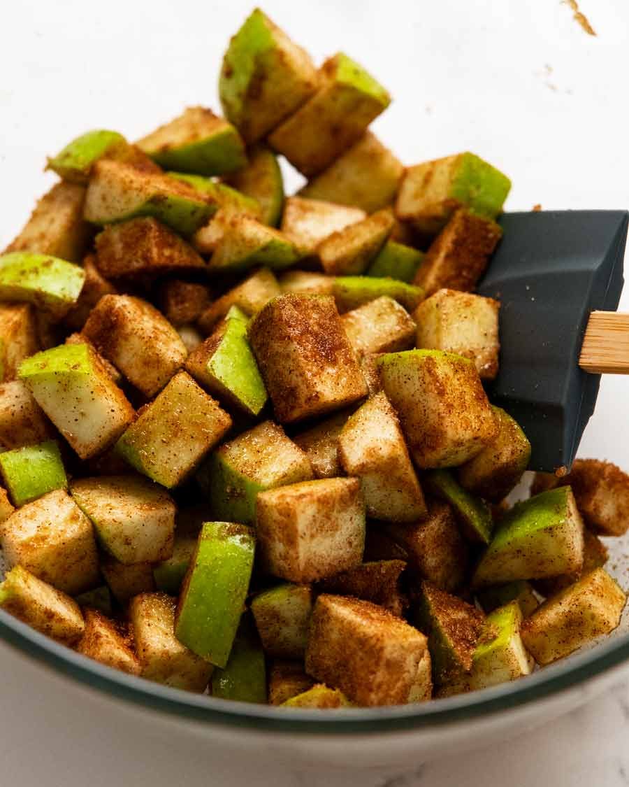 Cinnamon Apple Bread Recipe Tossing apples in cinnamon for Cinnamon Apple Bread