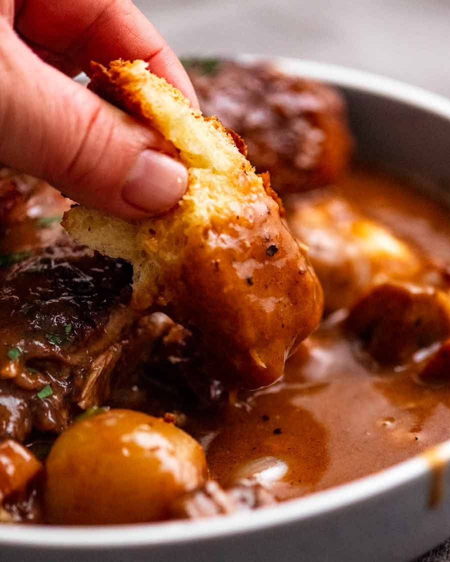 Coq au Vin Recipe Dipping brioche into Coq au Vin sauce