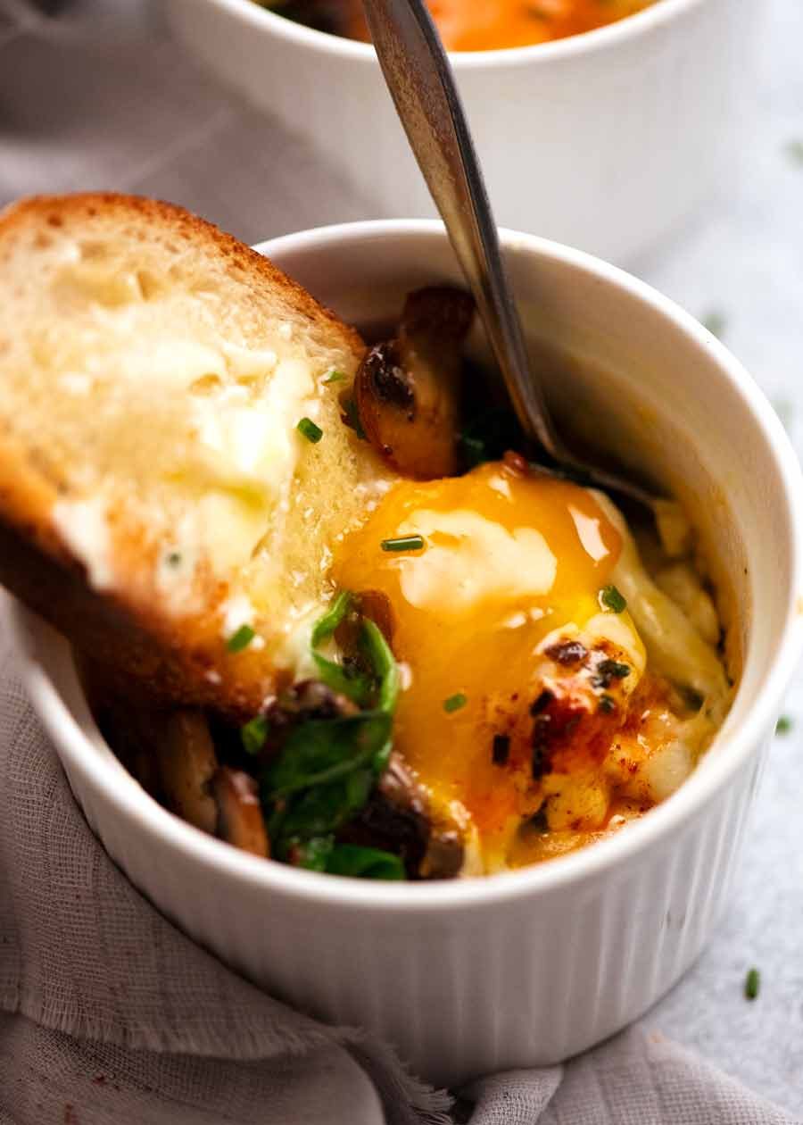 Shirred Eggs (Baked Eggs with Spinach & Mushrooms) Recipe Dunking bread into Baked Eggs - Shirred Eggs
