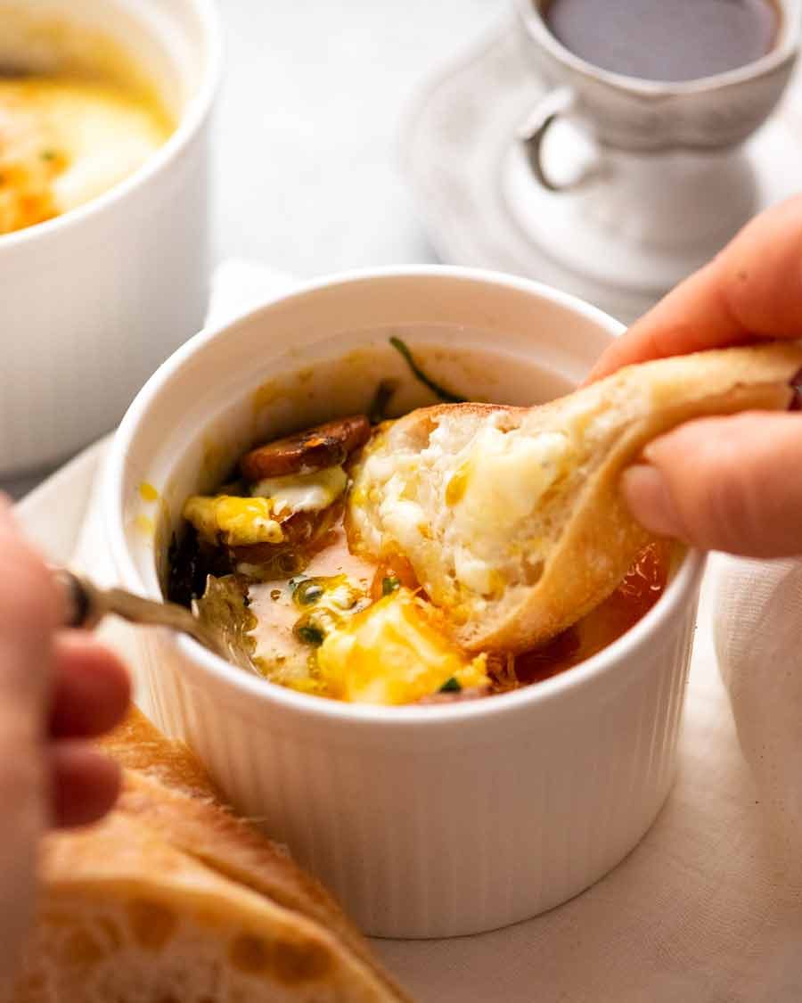 Shirred Eggs (Baked Eggs with Spinach & Mushrooms) Recipe Dunking bread into Baked Eggs - Shirred Eggs