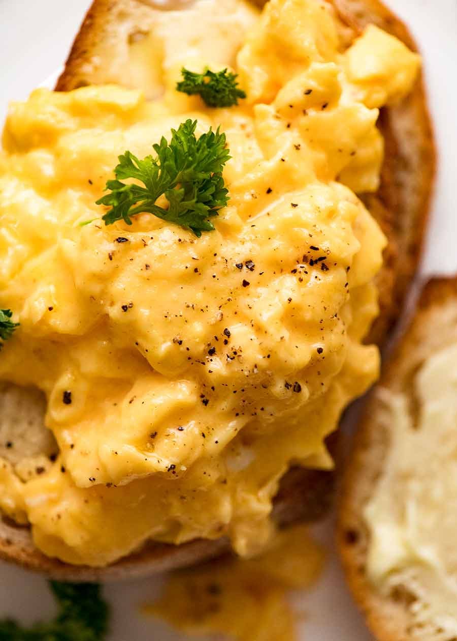 Scrambled Eggs Recipe Overhead photo of soft Scrambled Eggs on toast