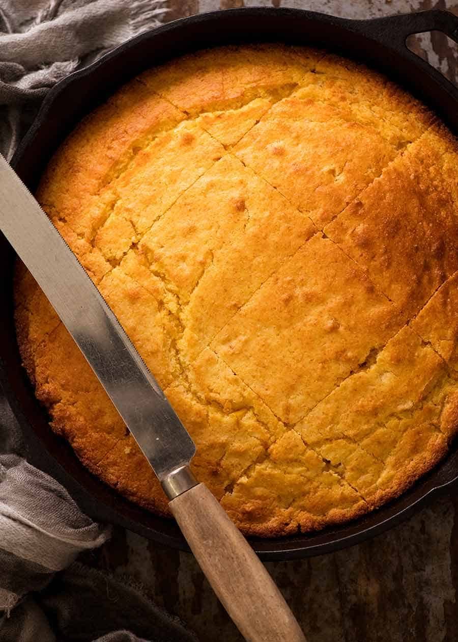 Cornbread recipe Overhead photo of Cornbread in a black skillet, fresh out of the oven