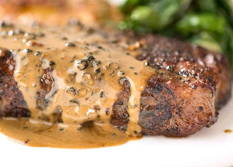 Steak with Creamy Peppercorn Sauce Recipe Close up of Creamy Peppercorn Sauce dripping down the side of steak