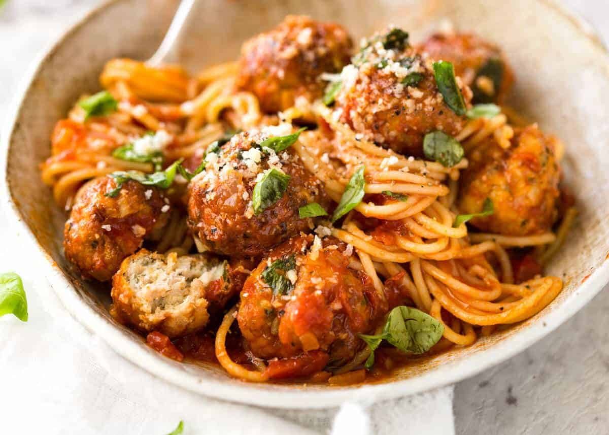 Baked Chicken Meatballs and Spaghetti Recipe Plump, juicy BAKED Chicken Meatballs and Spaghetti! They come out golden brown on the outside, and so soft and juicy on the inside. recipetineats.com
