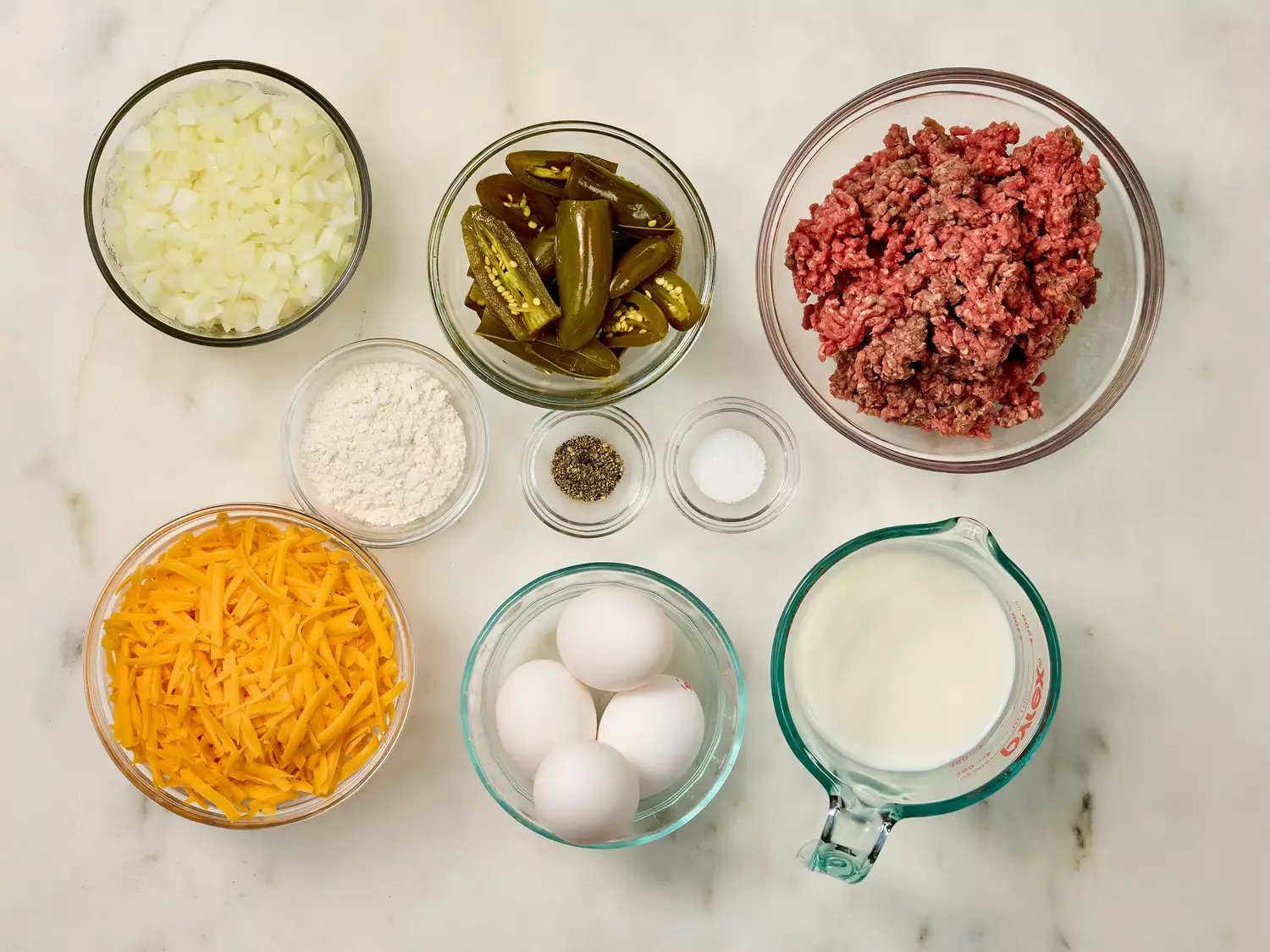 Ingredients for jalapeño casserole arranged in glass bowls.