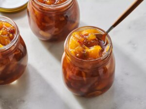 Close up on a few glass jars of mango chutney