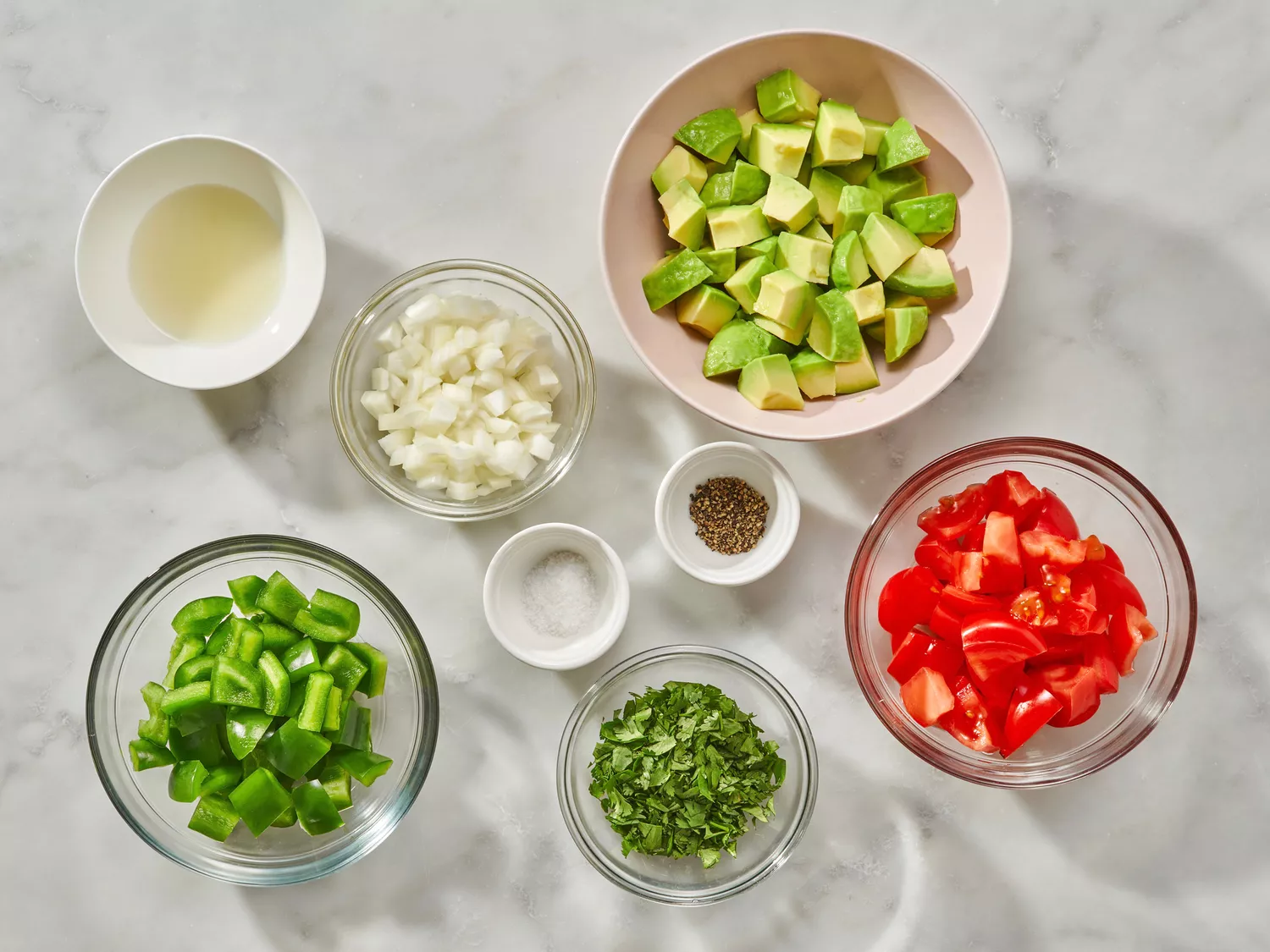 Avocado Salad recipe ingredients on a marble counter 