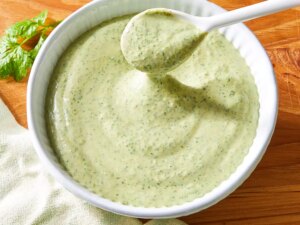 Amy's cilantro cream sauce in a bowl with a spoon