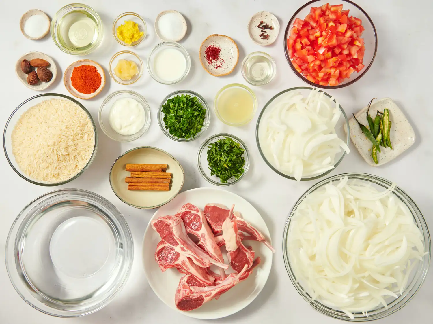 Ingredients for preparing lamb gosht biryani arranged on a countertop