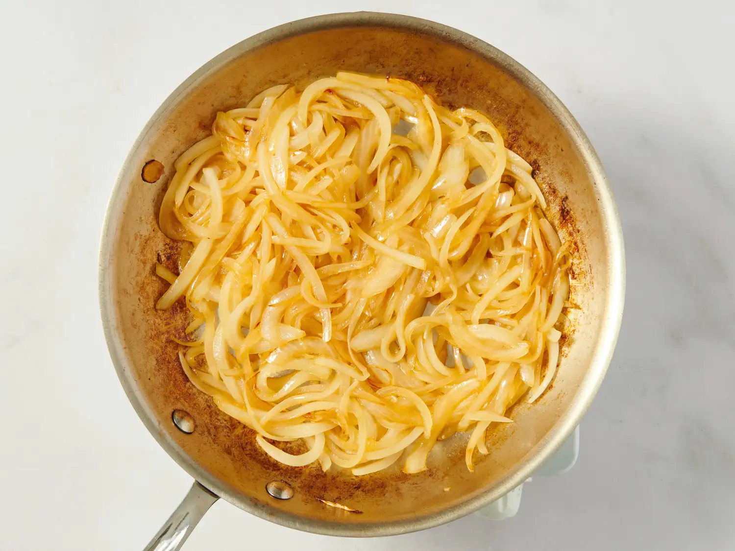 Cooked onions in a frying pan
