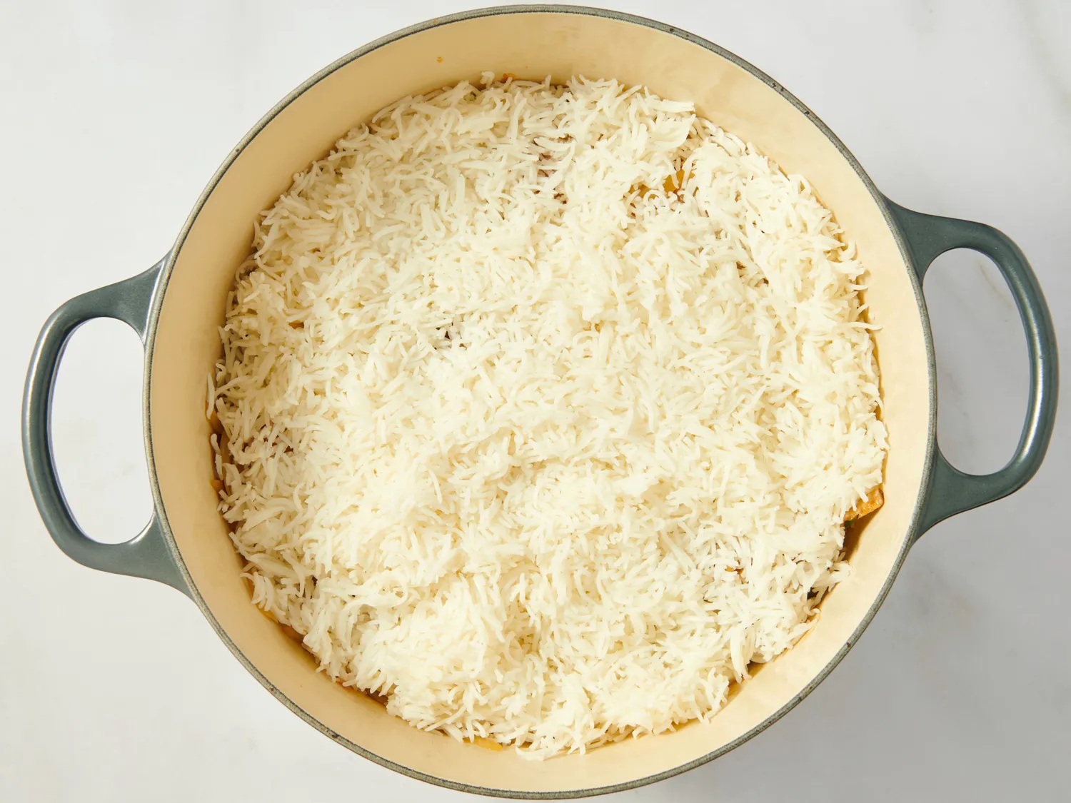 A pot filled with uncooked rice prepared for cooking biryani