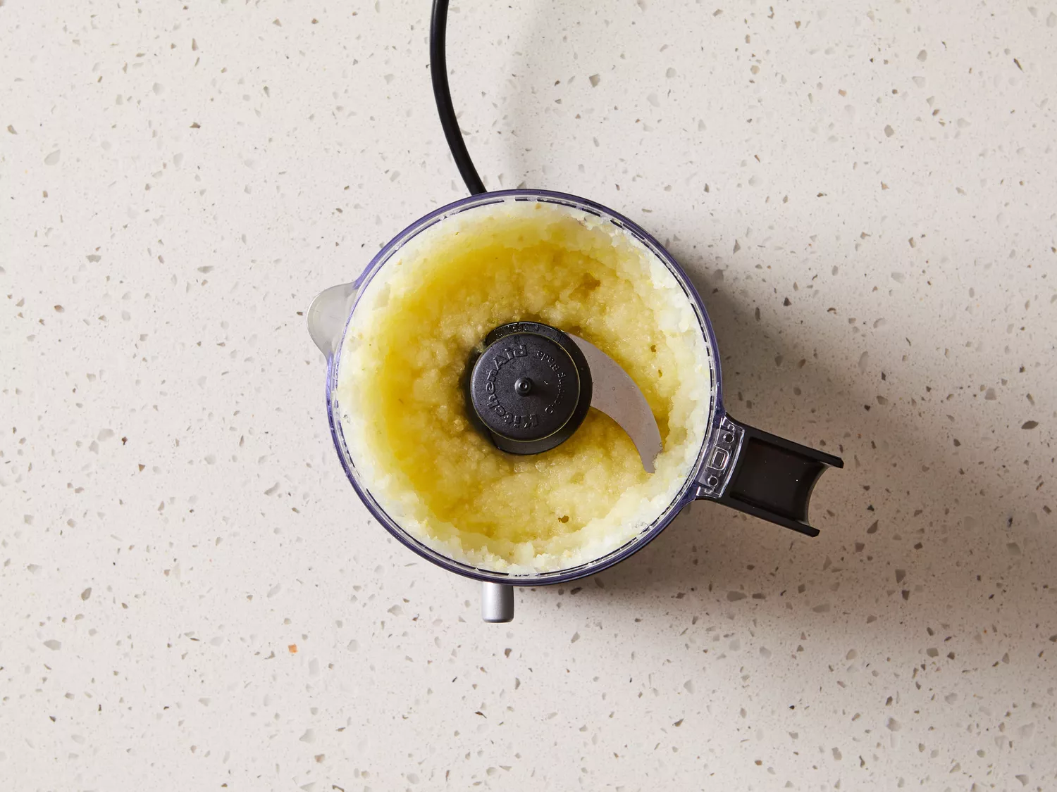 Onion, garlic, ginger, and cashews in a food processor