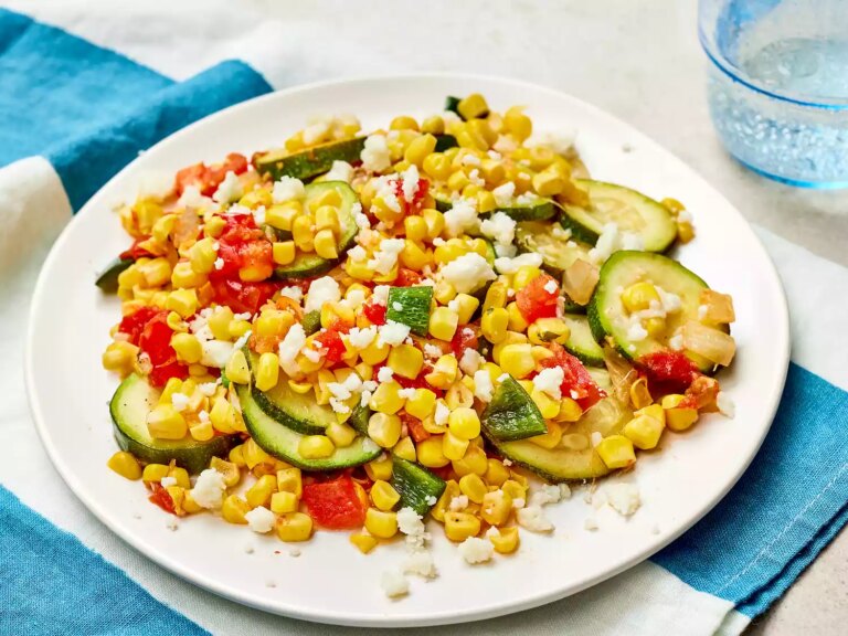 Calabacitas con elote (zucchini with corn) on a white plate