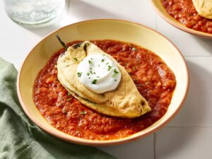Real chiles rellenos with sauce in bowls on a counter