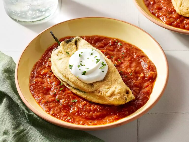 Real chiles rellenos with sauce in bowls on a counter