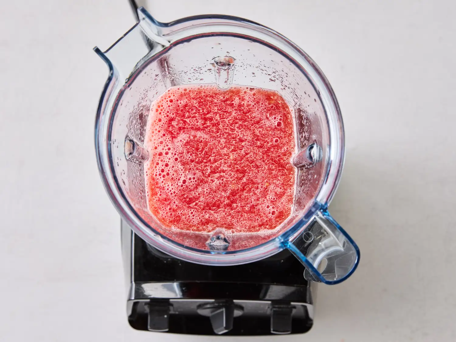 Blender containing blended watermelon mixture seen from above