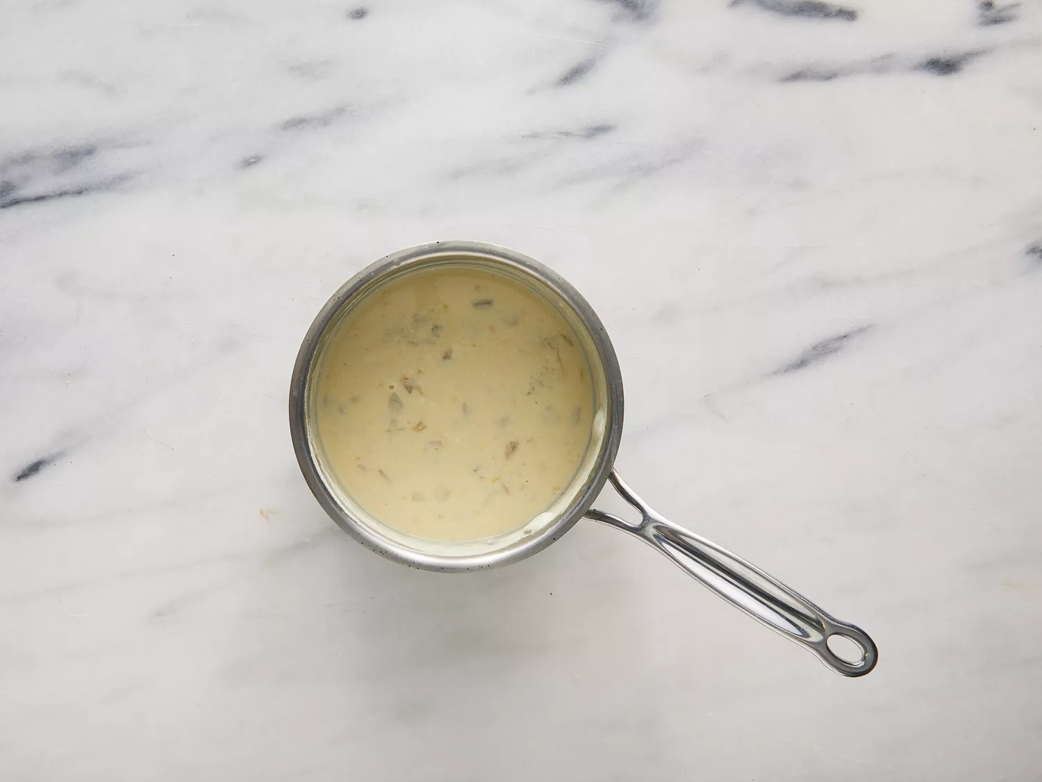 Overhead of a chimichanga sauce cooking in a pot. 