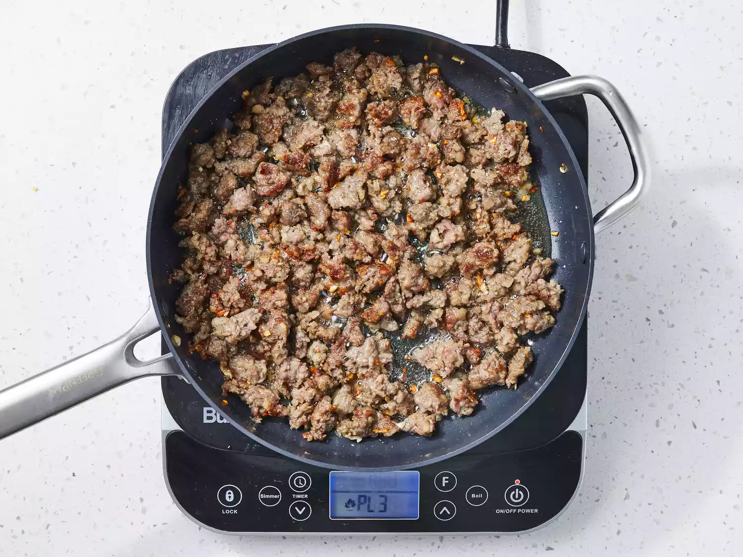 sausage, garlic and onion cooking until sausage is evenly browned.