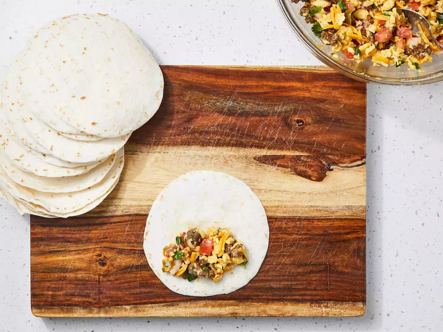 place some filling on the bottom center edge of the tortilla and roll while folding in the edges.